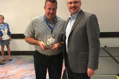 Matt Servant accepts the golf award for Closest to the Pin from Buzz Mills, WWT President